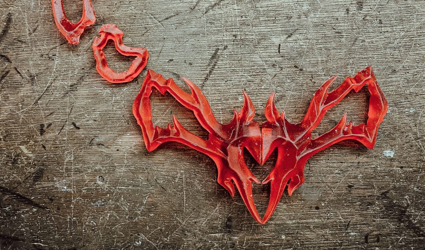 Cast metal collar photographed vertically under hard light