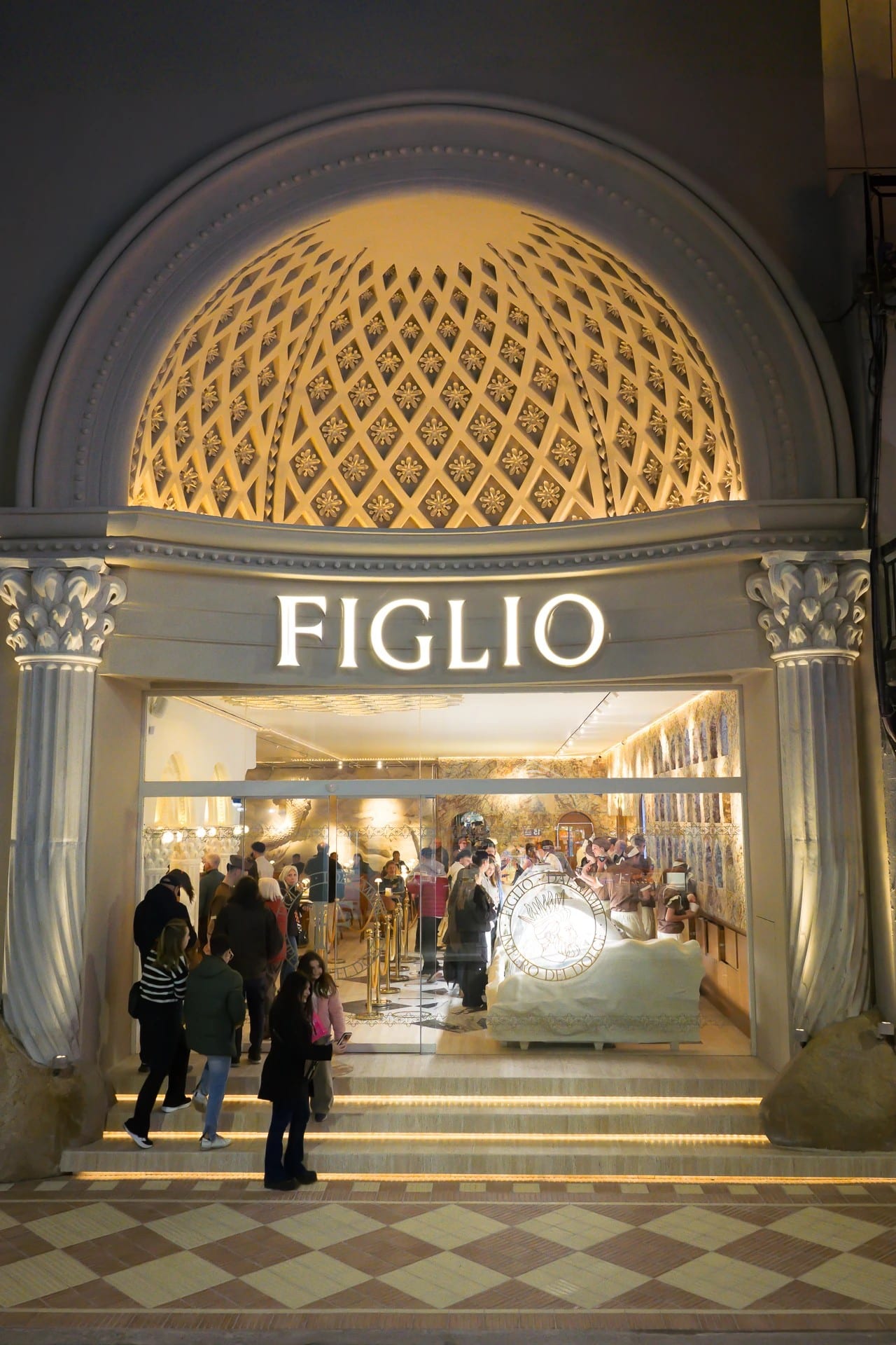 Lit facade of the Figlio gelateria with its coffered dome